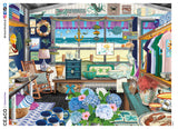 This 300 oversized piece puzzle by artist Tracy Flickinger depicts a beachside gift shop full of clever marine merchandise. The beach is clearly visible through a large picture window at the back of the store.